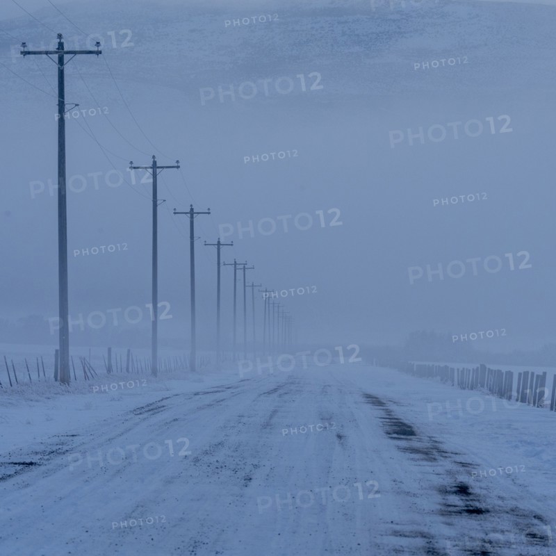 Empty frozen rural road in winter