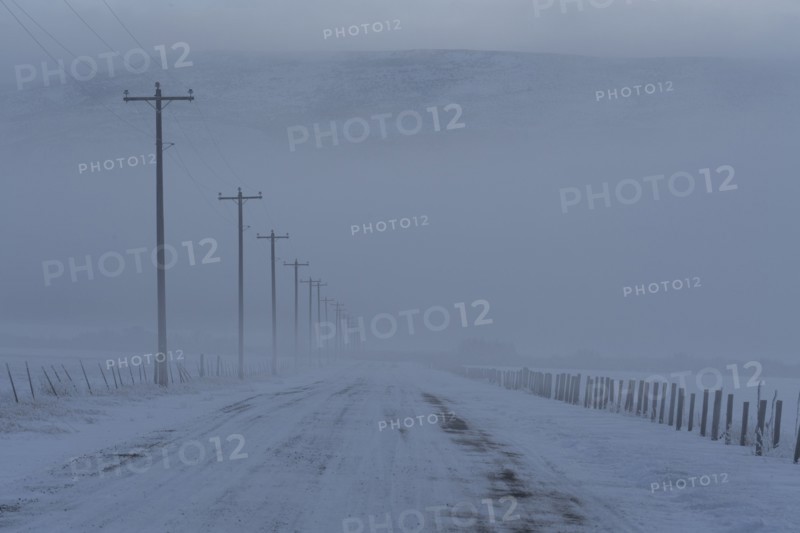 Empty frozen rural road in winter