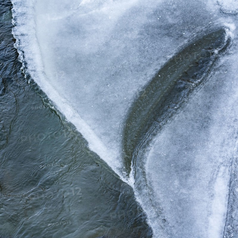 Edge of ice along river in winter