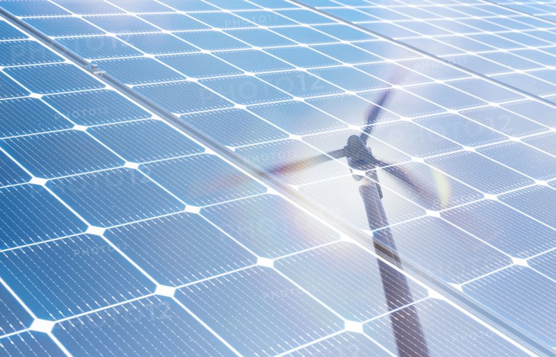 Wind turbine reflected in solar panels
