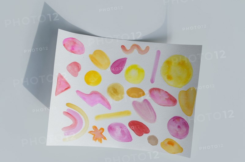 Studio shot of paper with colorful painted pattern