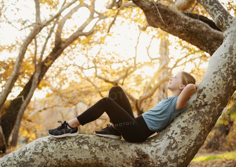 Girl relaxing on tree branch