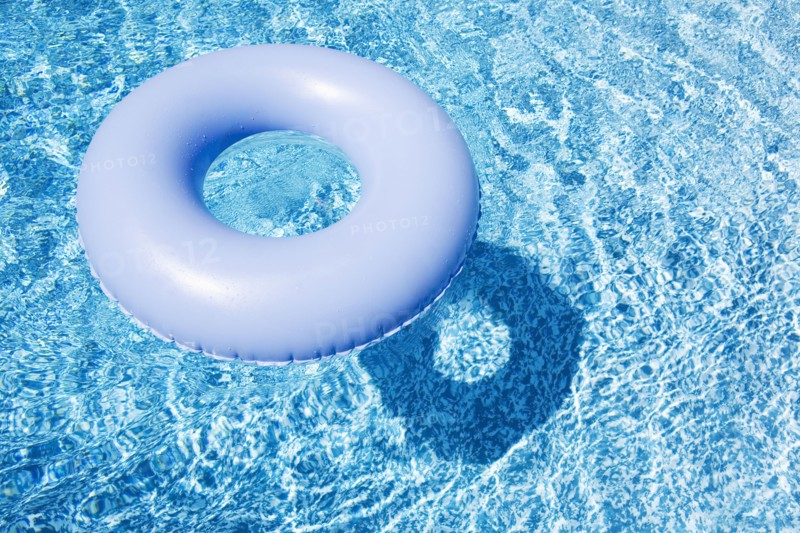 Blue inflatable ring floating on pool water surface