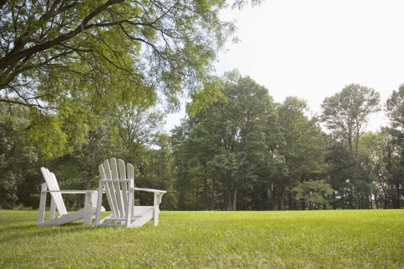 Pair of Adirondack chairs in back yard
