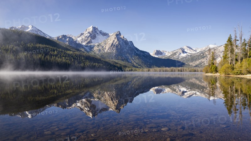 Sawtooth Lake surrounded with snowcapped Sawtooth mountains