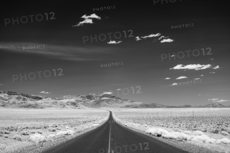 Empty road crossing desert landscape