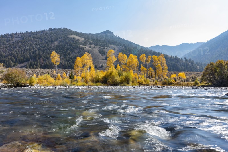 Big Lost River in autumn landscape with mountains and forests