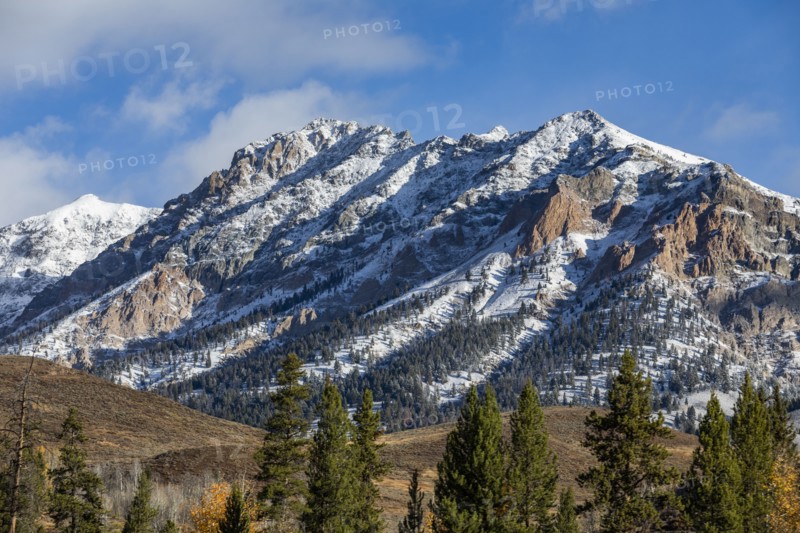 Landscape with snowcapped Rocky Mountains and autumn forests