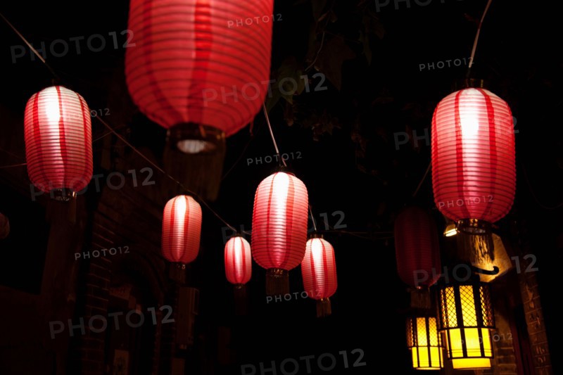 Paper lanterns on city street at night