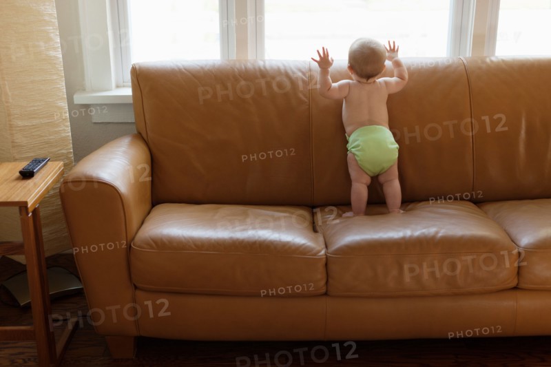Baby boy playing on sofa