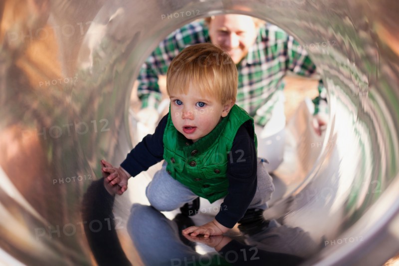 Boy climbing up slide in playground