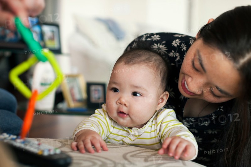 Close up of parents playing with baby daughter