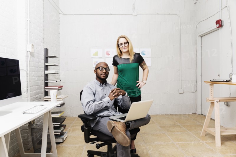 Portrait of young business partners in design office