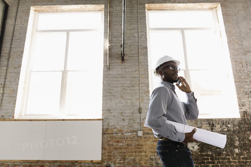 Young interior designer looking at new office space