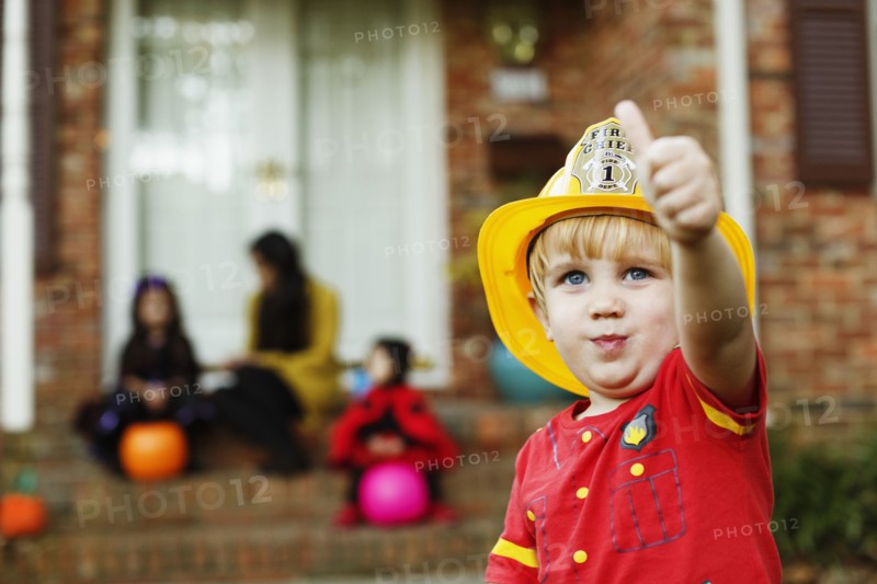 Boy wearing fireman's helmet