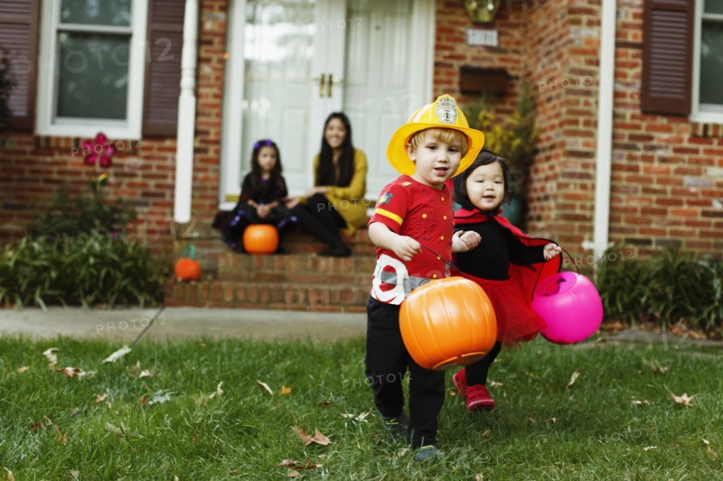 Boy dressed as fireman with trick or treat bucket