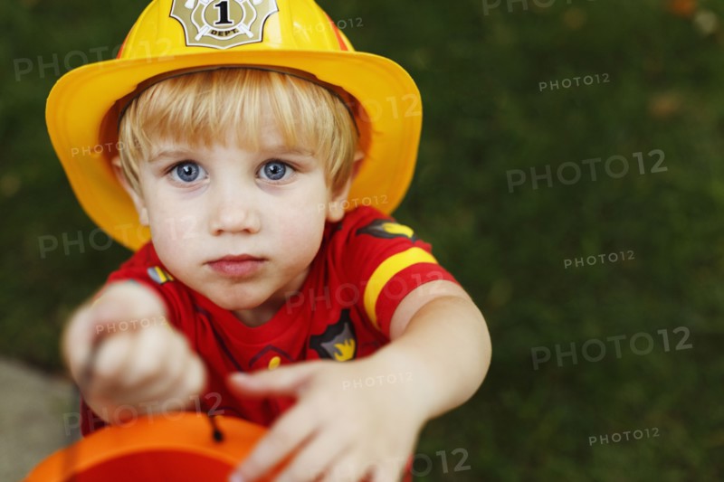 Boy wearing fireman's helmet