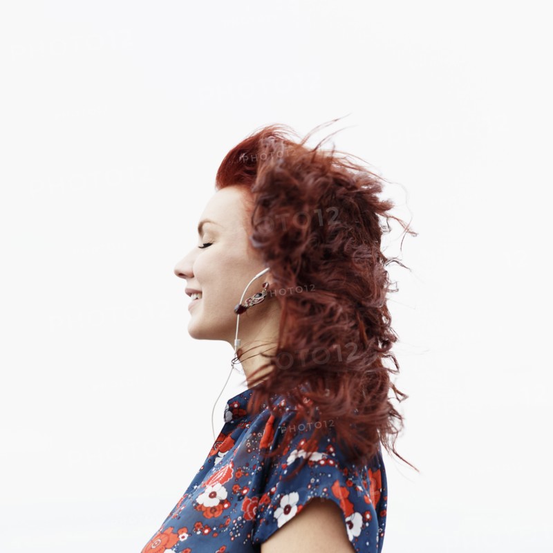 Profile of young woman with long red hair
