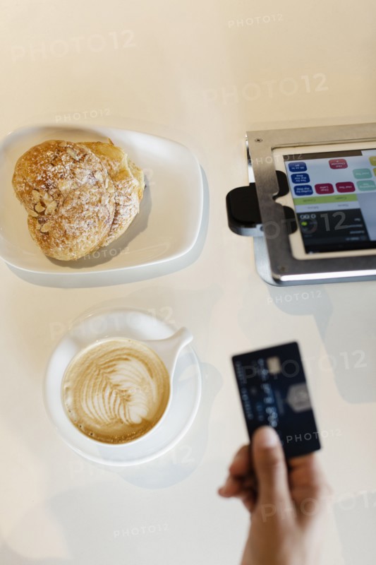 Customer paying for coffee in coffee shop