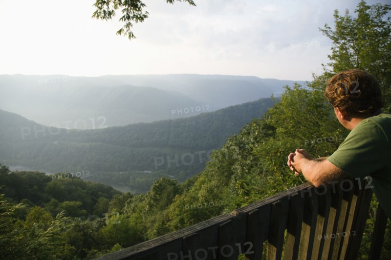 Mid adult man looking at view from viewing platform