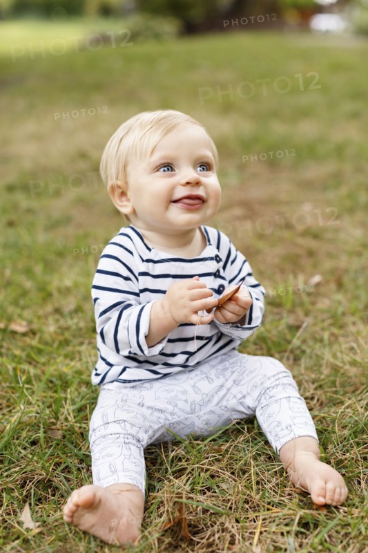 Portrait of baby girl sitting on grass