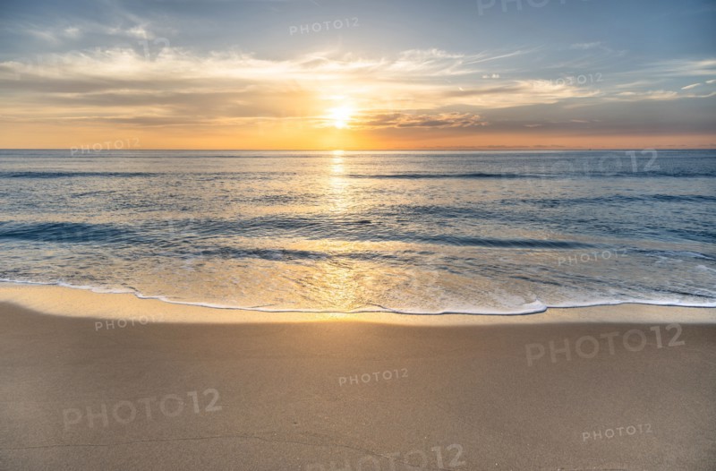 Sun rising above sea