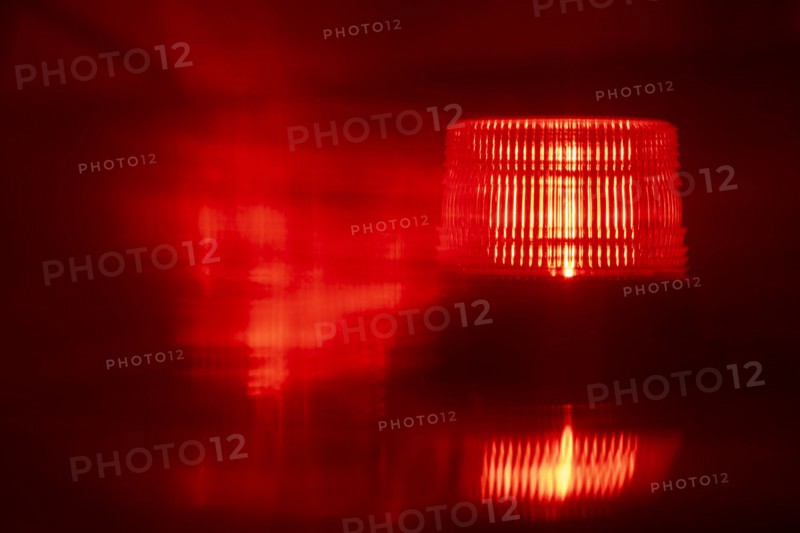 Close-up of flashing red emergency light at night