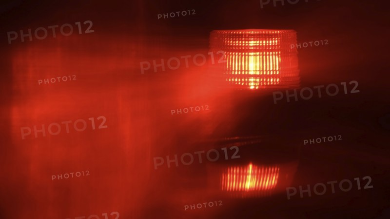 Close-up of flashing red emergency light at night