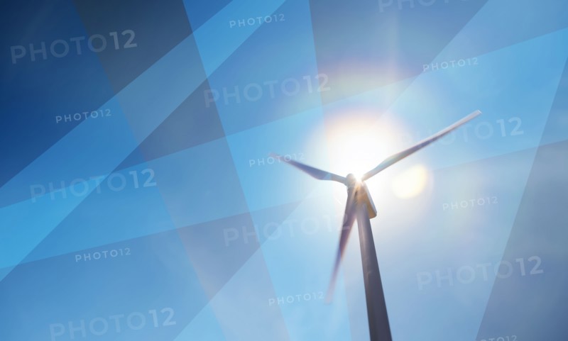 Wind turbine against sky and sun