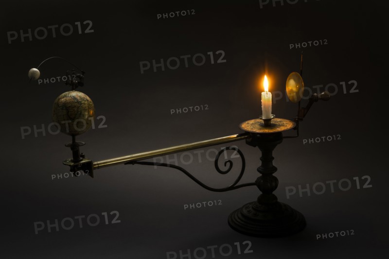 Antique globe and candle solar system model