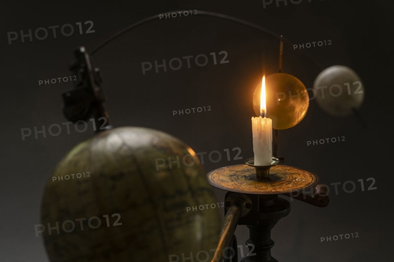 Antique globe and candle solar system model