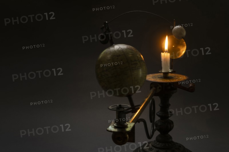 Antique globe and candle solar system model