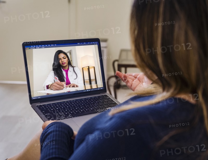 Woman having video call with doctor