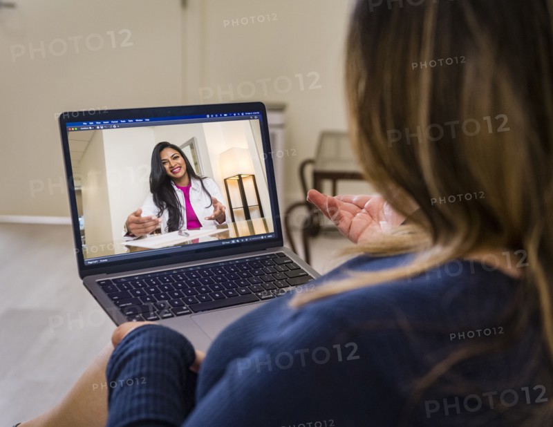Woman having video call with doctor