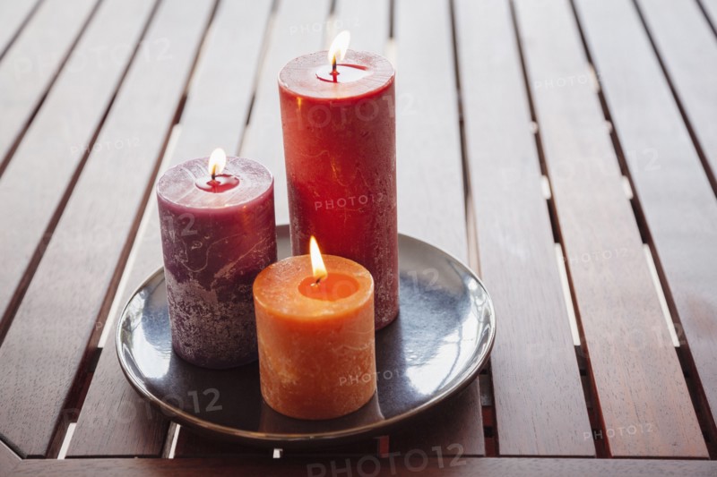 Candles and stones on wooden table