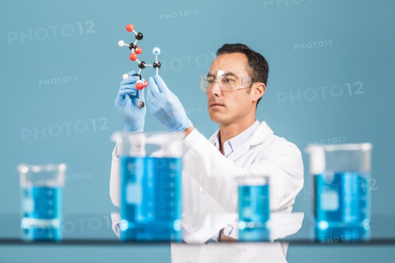 Scientist holding molecule model
