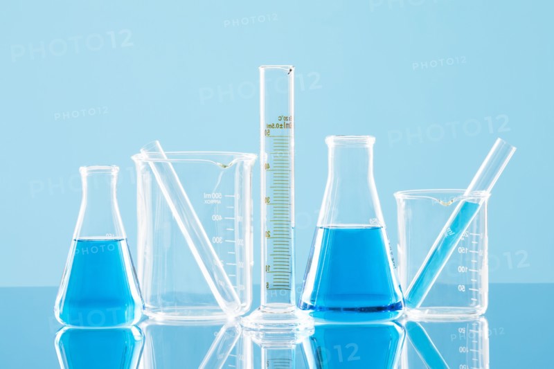 Laboratory glassware against blue background