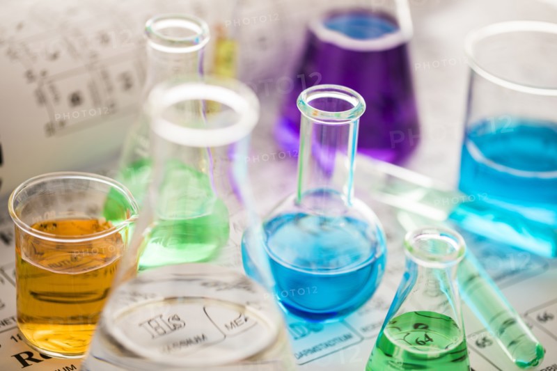 Laboratory glassware with liquids on periodic table