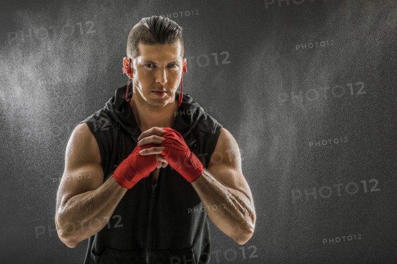 Portrait of muscular man in boxing gloves