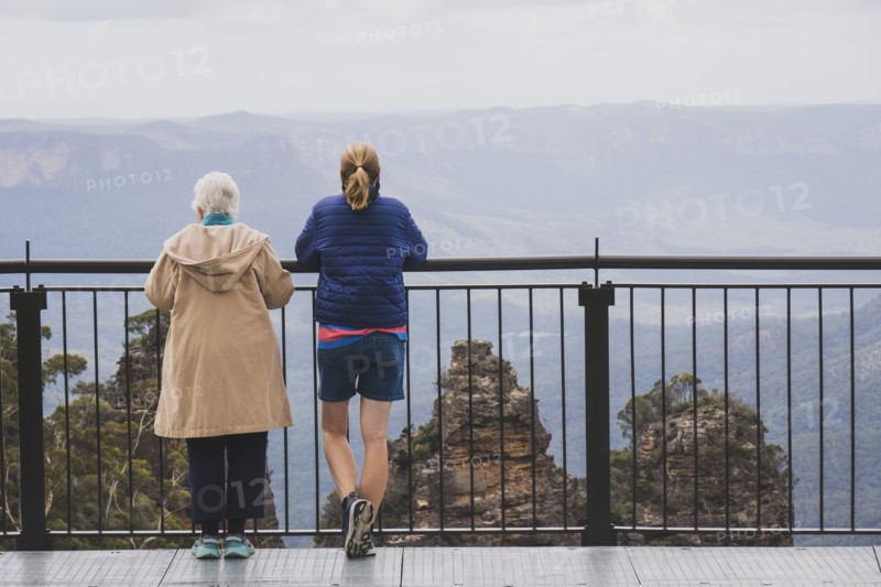 Rear view of two women standing together