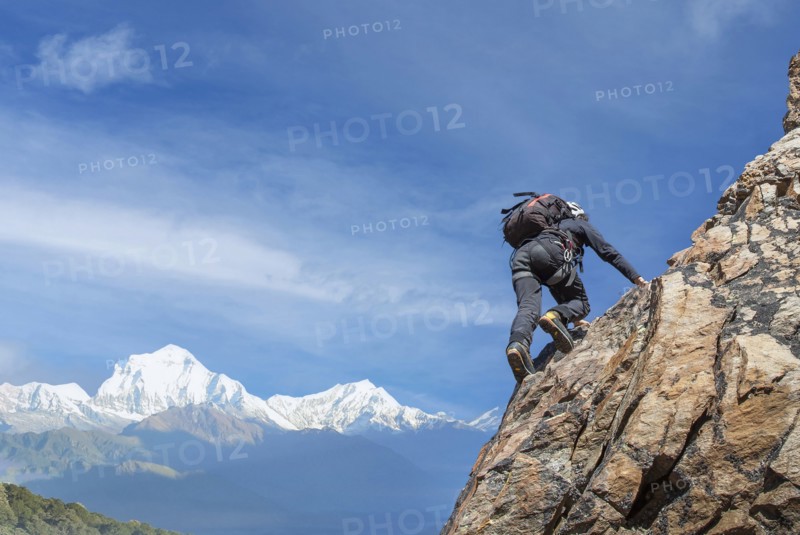 Man climbing rocky wall of Mont Blanc