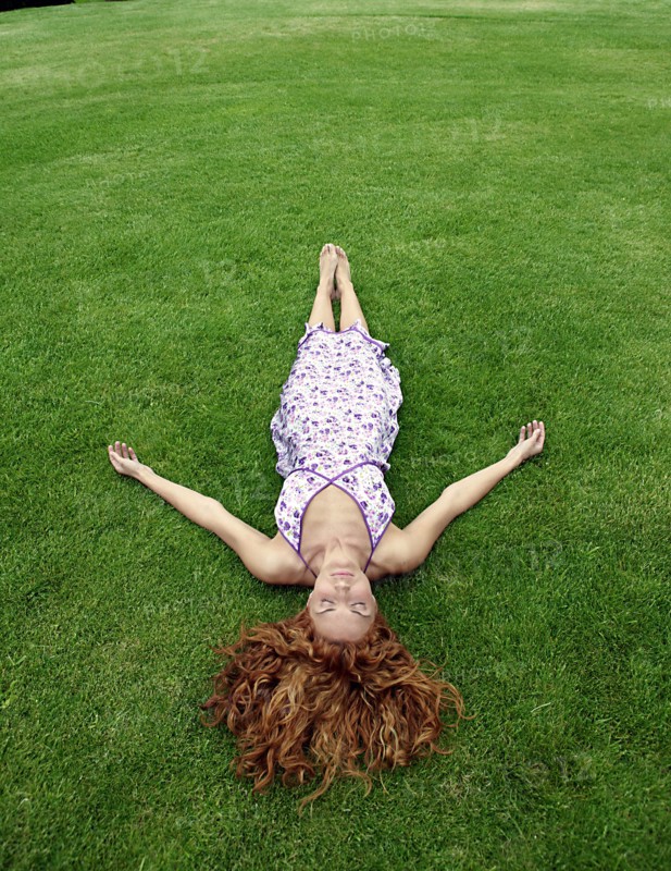 Young woman lying in lawn