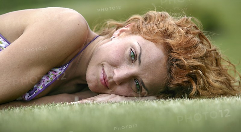 Young woman lying on grass