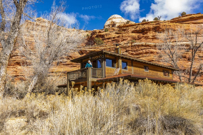 Woman on deck of home in canyon in Grand Staircase-Escalante National Monument