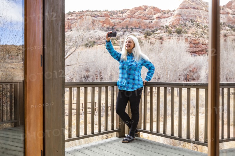 Woman on deck of home in canyon in Grand Staircase-Escalante National Monument