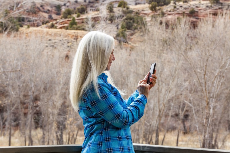 Woman using smart phone in Grand Staircase-Escalante National Monument