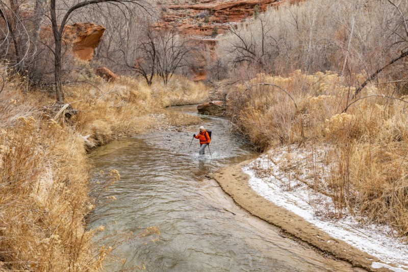 Woman wading across Escalante River in Grand Staircase-Escalante National Monument