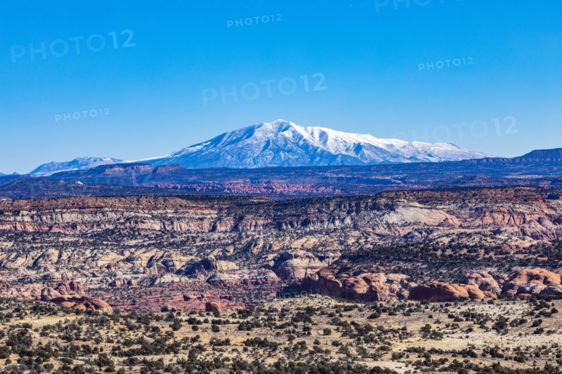 Distant snowy mountains in rocky landscape of Grand Staircase-Escalante National Monument