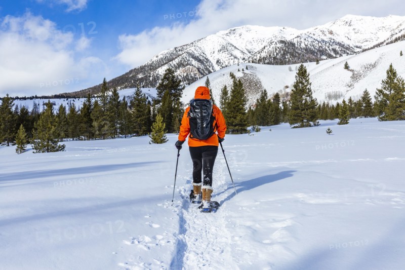 Woman snowshoeing in mountains