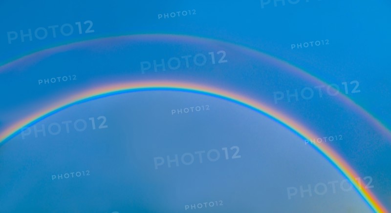 Double rainbow on blue sky